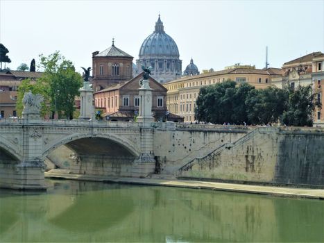 A Bridge over the Tiber river in Rome, Italy with Saint Peters Basilica