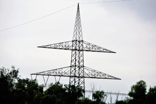 Photo of an electrical tower behind trees