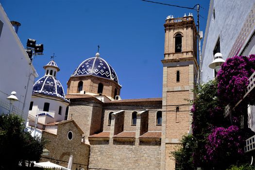 Our Lady of Solace church in Altea, Spain with Bougainvillea plants