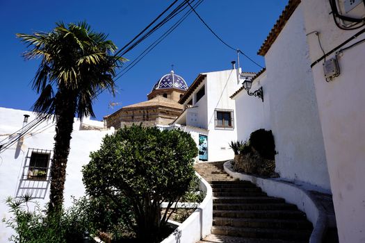 Typical white houses, steps and church in Altea, Spain