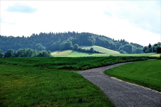 Agricultural road with view to a hill in Weinheim Oberflockenbach, Germany
