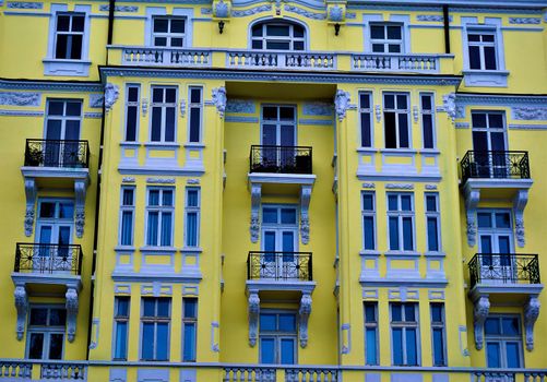 Beautiful yellow building with windows, balconies and stucco in Sofia, Bulgaria