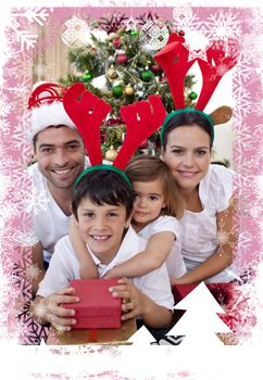 Lovely family giving presents for Christmas against christmas themed frame