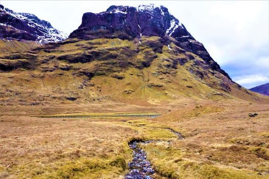 Beatiful view to the Three Sisters in Scotland with creek