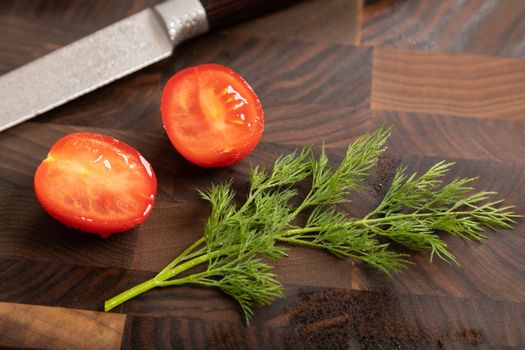 Fresh vegetables and greens on wooden cutting board