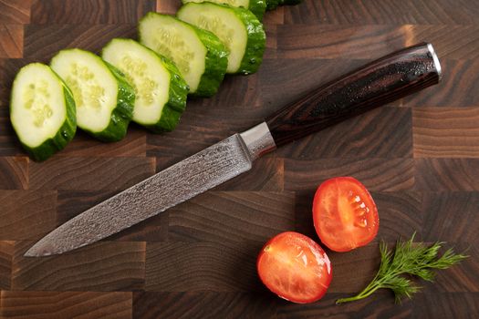 Fresh vegetables and greens on wooden cutting board
