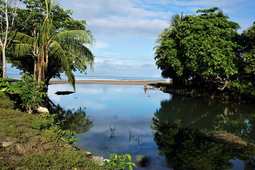 Tropical view on river mouth at Jaco beach, Costa Rica