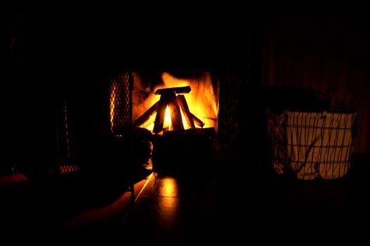 Logs burning beautifully in an orange and red flame in the fireplace