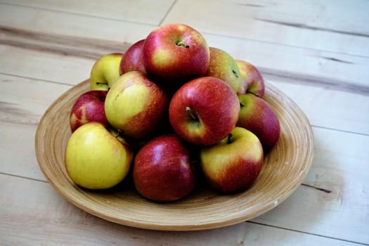Still life of apples in a bowl on wooden floor