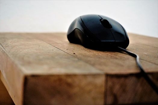 Side view of computer mouse on wooden table