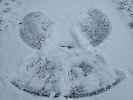 A photo of a snow angel on a path
