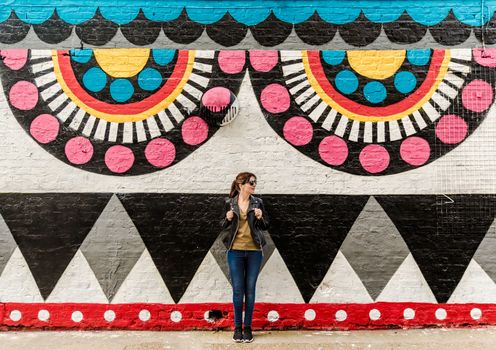 Beautiful woman in front of a colored wall