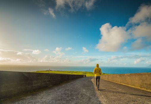 Young traveller woman walking by the road