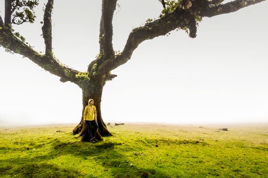 Traveller woman feeling the power of the nature at an ancient forest