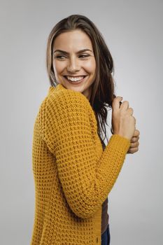 Shot of a beautiful young woman over a gray background