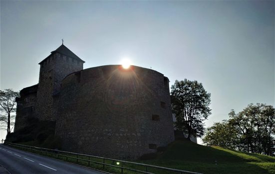 The sun is rising over Vaduz castle in Liechtenstein