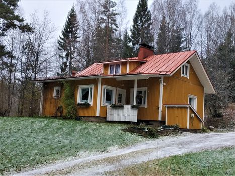 Traditional yellow wooden house in the Nuuksio National Park, Finland