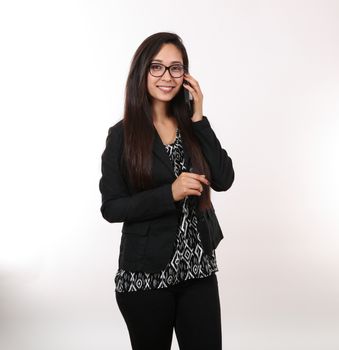 A young latina takes a business call.