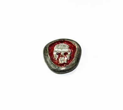 A stone with relief in the form of a skull and blood. Grim creativity.