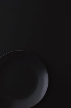 Empty plates on black background, premium dishware for holiday dinner, minimalistic design and diet concept