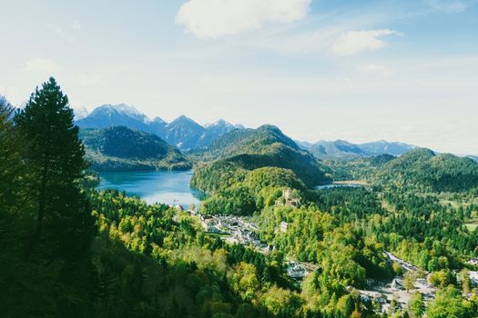 Beautiful nature of European Alps, landscape view of alpine mountains, lake and village in spring season, travel and destination scenery