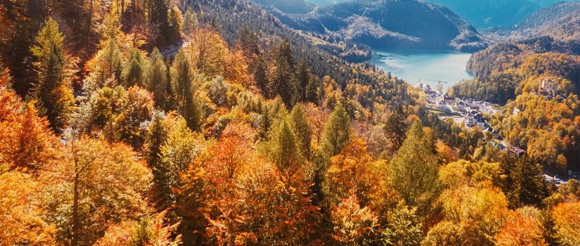 Beautiful nature of European Alps, landscape view of alpine mountains, lake and village in autumn season, travel and destination scenery