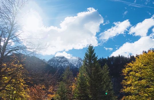 Beautiful nature of European Alps, landscape view of alpine mountains, lake and village on a sunny day, travel and destination scenery