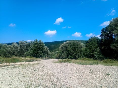 A shallow mountain river, the bottom of a mountain river of stones and gravel.