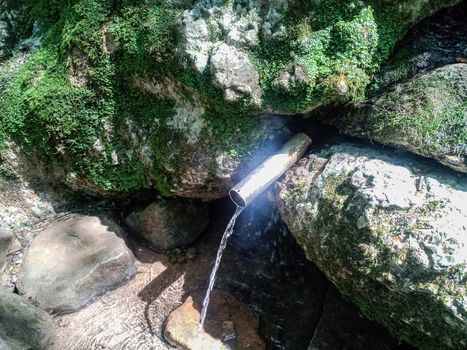 a tube inserted into the spring for the convenience of a set of drinking water. Shapsug Forest, Shapsugskaya Village.