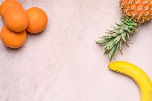 Tropical and Seasonal Summer Fruits. Pineapple Oranges and Bananas Arranged in corner of backgrounds, Healthy Lifestyle. Flat Lay