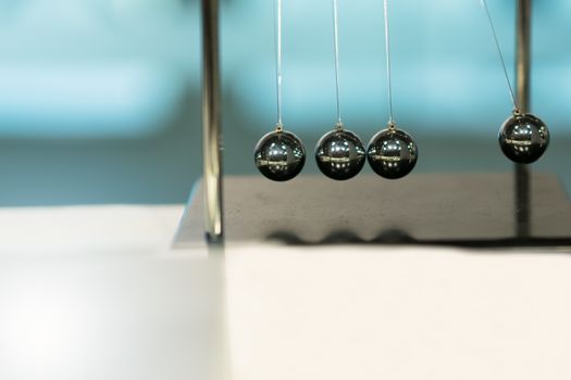 Balancing Balls Newton's Cradle on blurred backgrounds