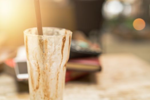 empty cup of iced mocha coffee on wooden table background.