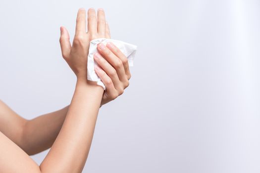 Woman cleaning her hands with white soft tissue paper. isolated on a white backgrounds