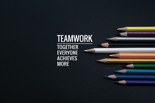 Teamwork concept. group of color pencil on black background with word Teamwork, Together, Everyone, Achieves and More