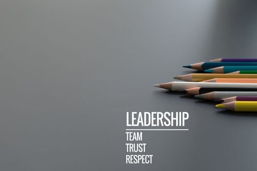 Leadership business concept. Gold color pencil lead other color with word Leadership, team, trust and respect on black background