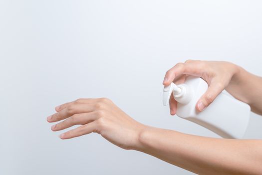 Body Lotion Skin Care Apply. women hands holding body cream pump bottle. Beauty And Body Care Concept
