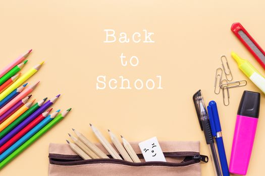 Welcome back to school background, colorful color pencil and stationery bag on yellow backgrounds with copy space