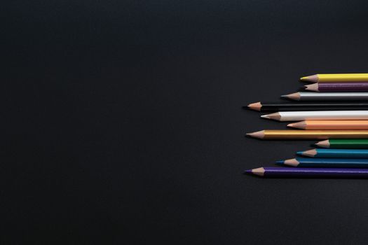 Teamwork concept. group of color pencil on black background