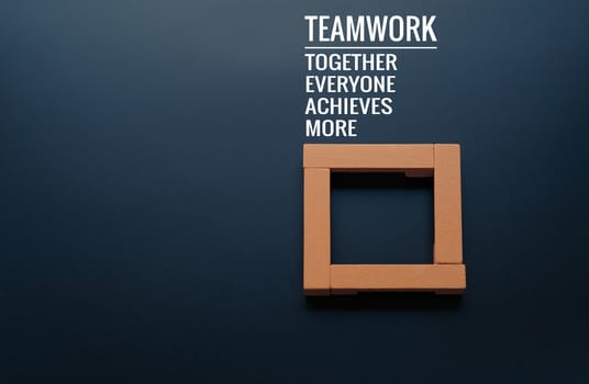Teamwork concept. group of wooden square on the black backgrounds with word Teamwork, Together, Everyone, Achieves and More