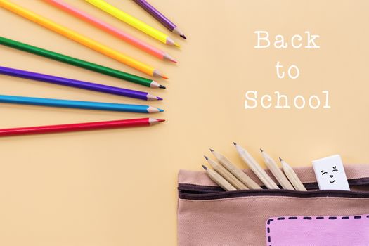 Welcome back to school background, colorful color pencil and stationery bag on yellow backgrounds with copy space