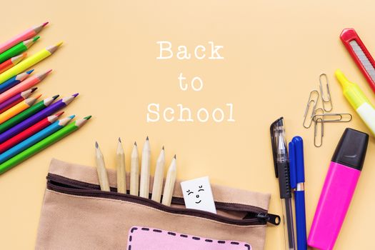 Welcome back to school background, colorful color pencil and stationery bag on yellow backgrounds with copy space