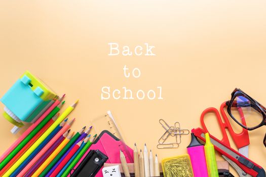 Welcome back to school background, colorful color pencil and stationery bag on yellow backgrounds with copy space