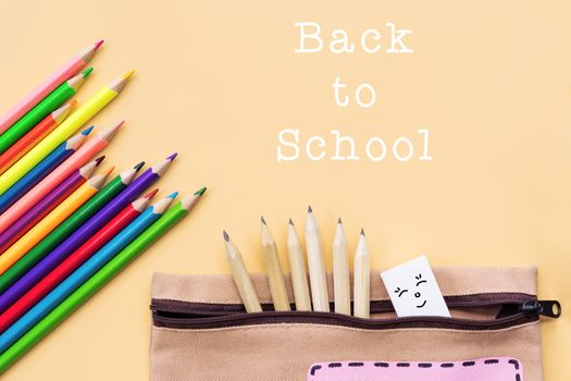 Welcome back to school background, colorful color pencil and stationery bag on yellow backgrounds with copy space