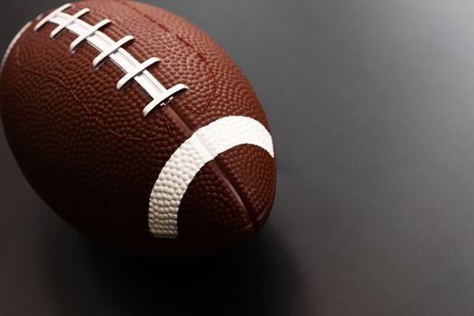 American football isolated on black background . Sport object concept