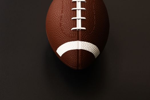 American football isolated on black background . Sport object concept