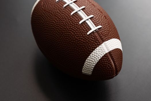 American football isolated on black background . Sport object concept