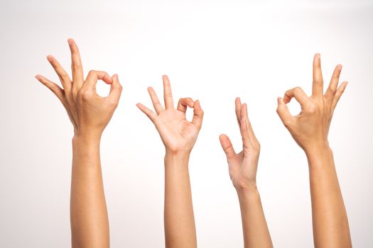 women hand OK sign and raise hand up gesturing on white background in four action