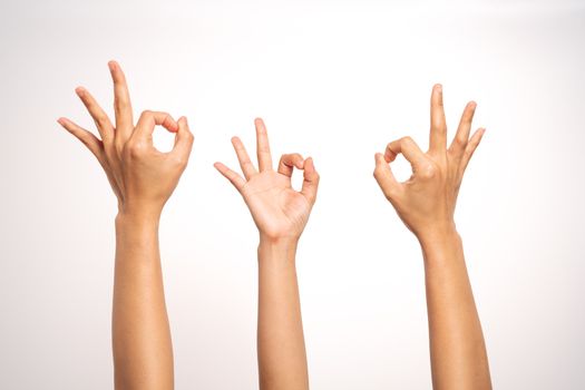 women hand OK sign gesturing on white background in three action