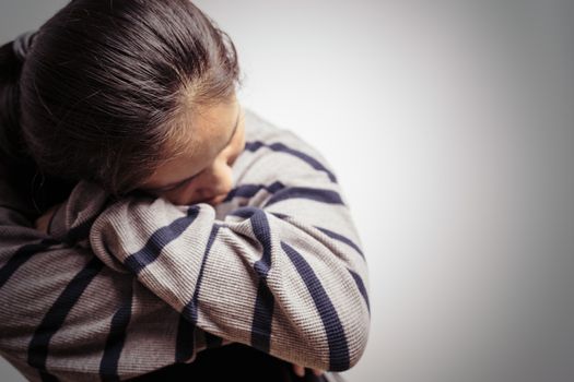 depressed women sitting in the dark room, alone, sadness, emotional concept