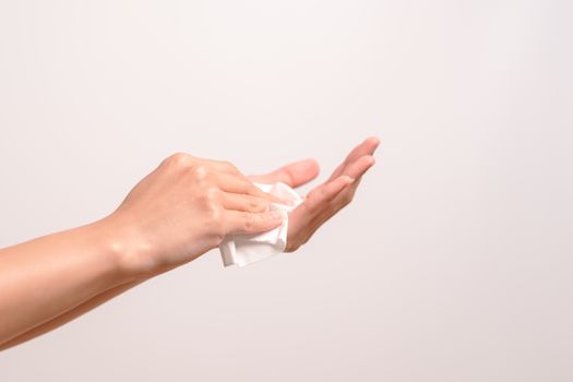 Woman cleaning her hands with white soft tissue paper. isolated on a white backgrounds